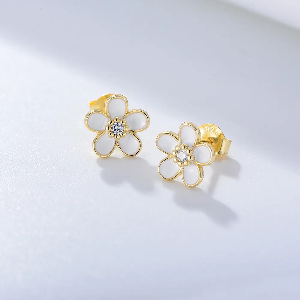Gold flower stud earrings with white enamel petals and cubic zirconia center, minimalist 925 silver jewelry.