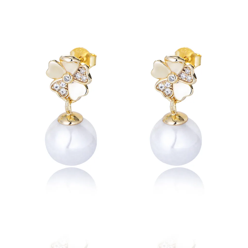 Gold floral pearl drop earrings with white enamel petals and CZ accents, elegant 925 sterling silver jewelry.