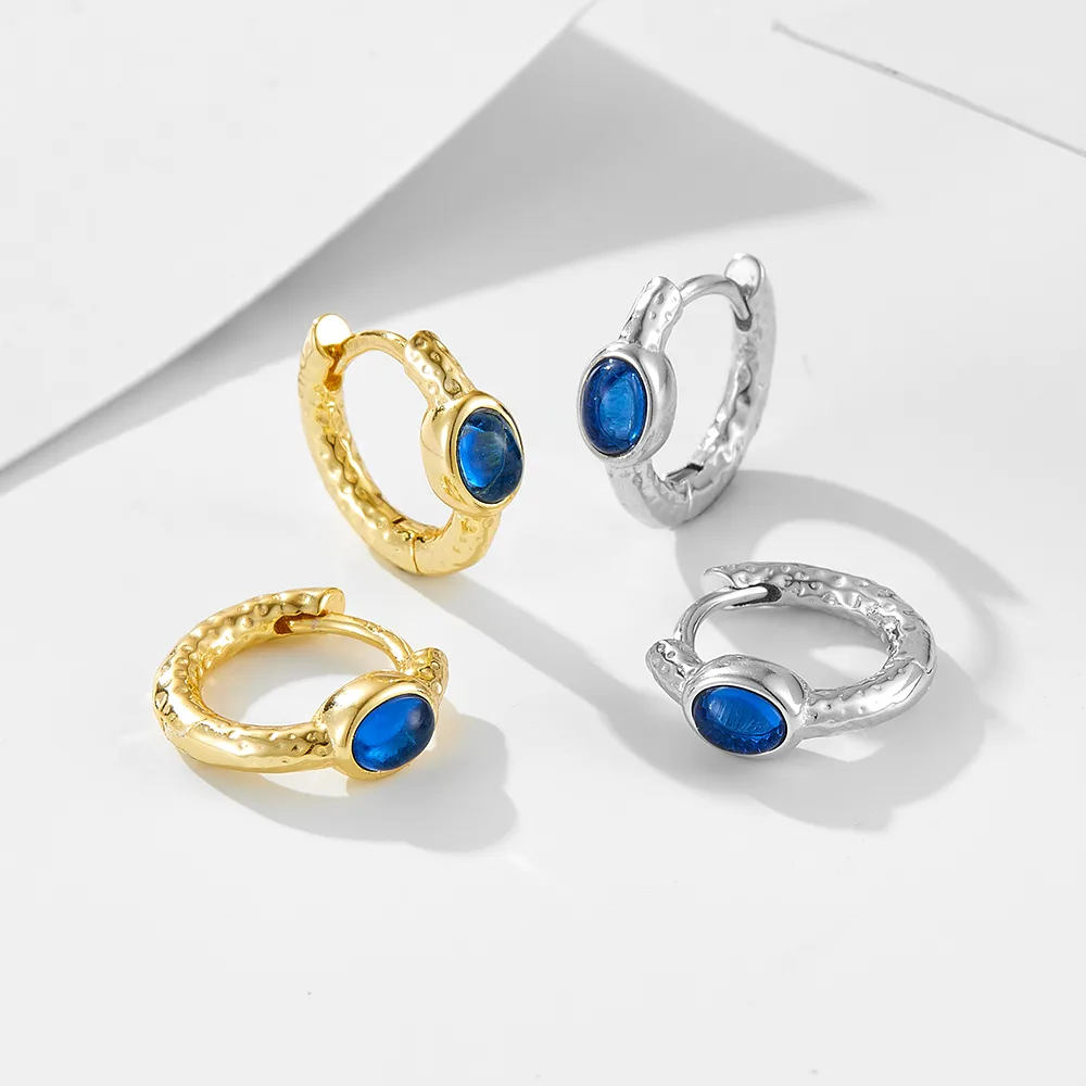 Blue gemstone hoop earrings in gold and silver tones, handcrafted 925 sterling silver jewelry with hammered finish.
