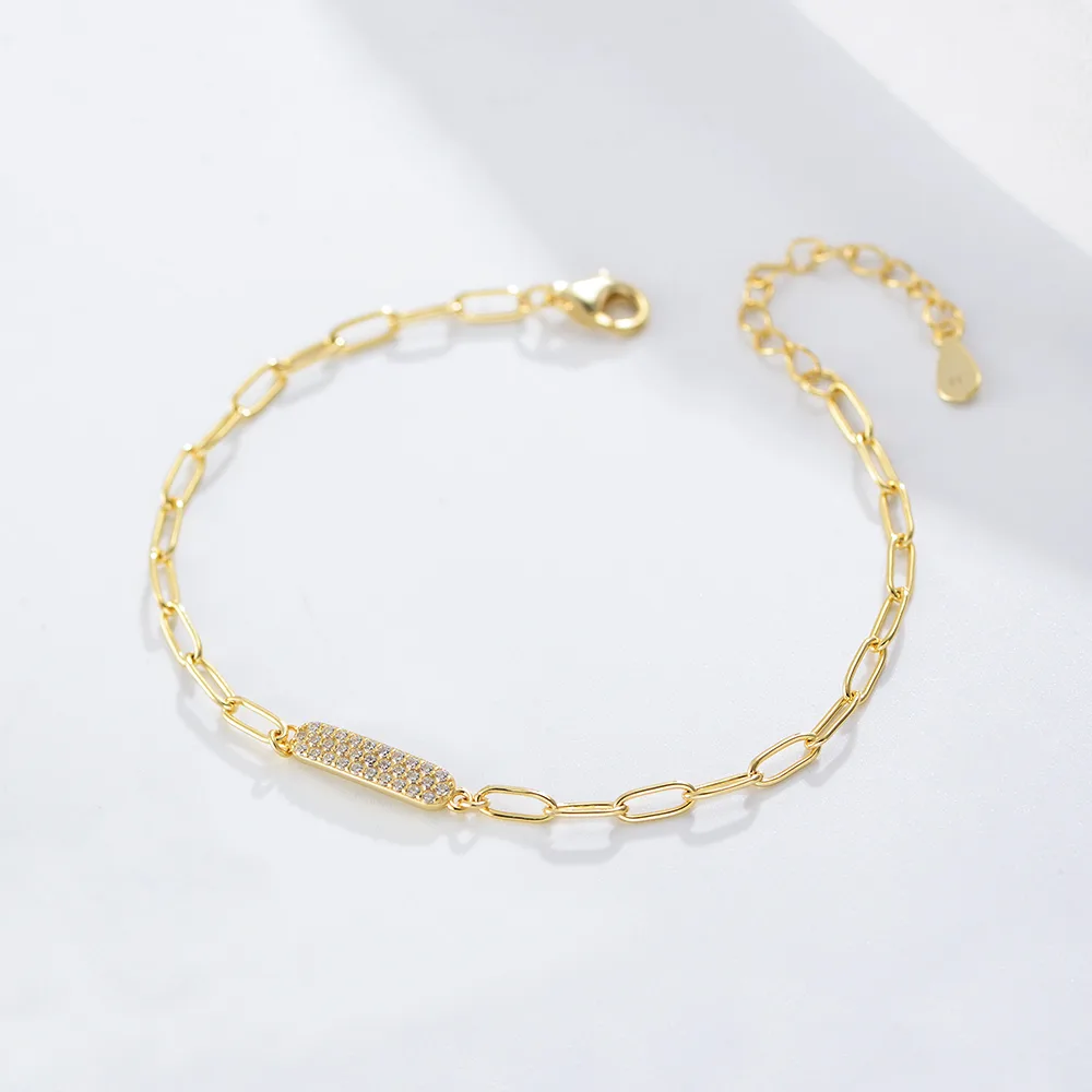Gold paperclip chain bracelet with pavé cubic zirconia bar, trendy minimalist jewelry for daily wear.