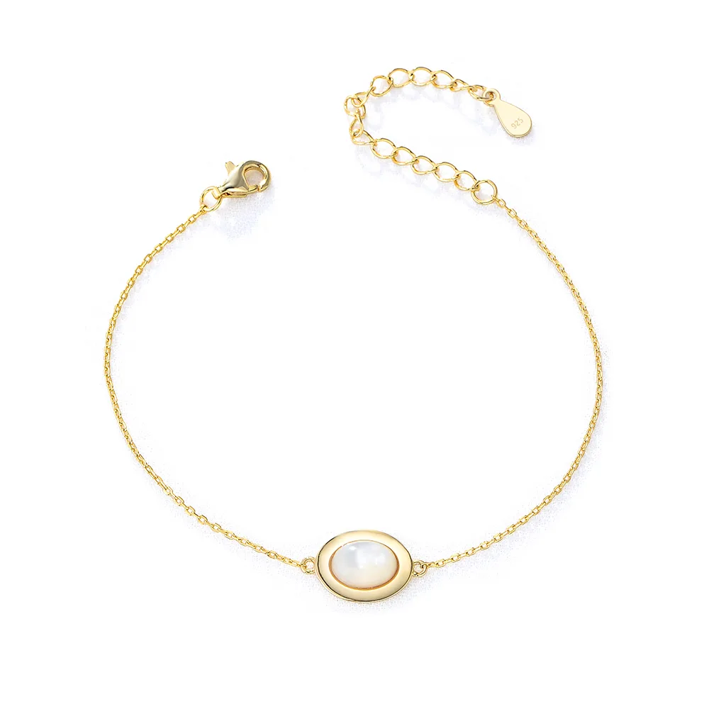 Elegant gold bracelet with white mother-of-pearl centerpiece, minimalist jewelry handcrafted by Dorji Jewelry.