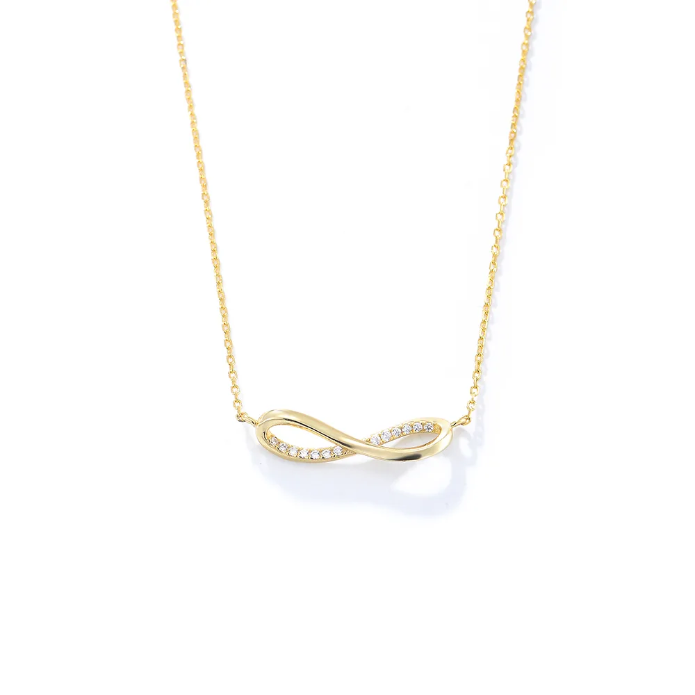 Infinity symbol pendant necklace in gold plating with pavé cubic zirconia, timeless design representing love and eternity.
