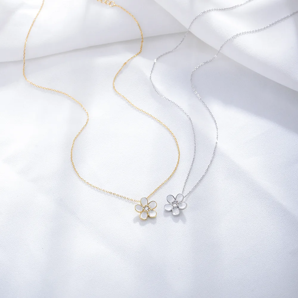 Floral pendant necklaces in gold and silver tones, delicate daisy design with cubic zirconia center for everyday elegance.