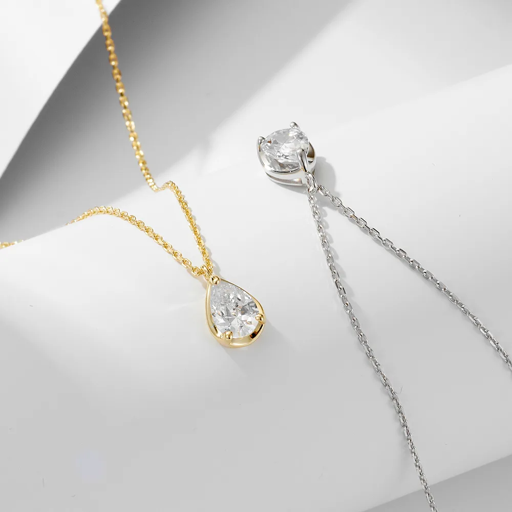 Teardrop cubic zirconia pendant necklace in gold and silver tones, minimalist jewelry for everyday elegance.