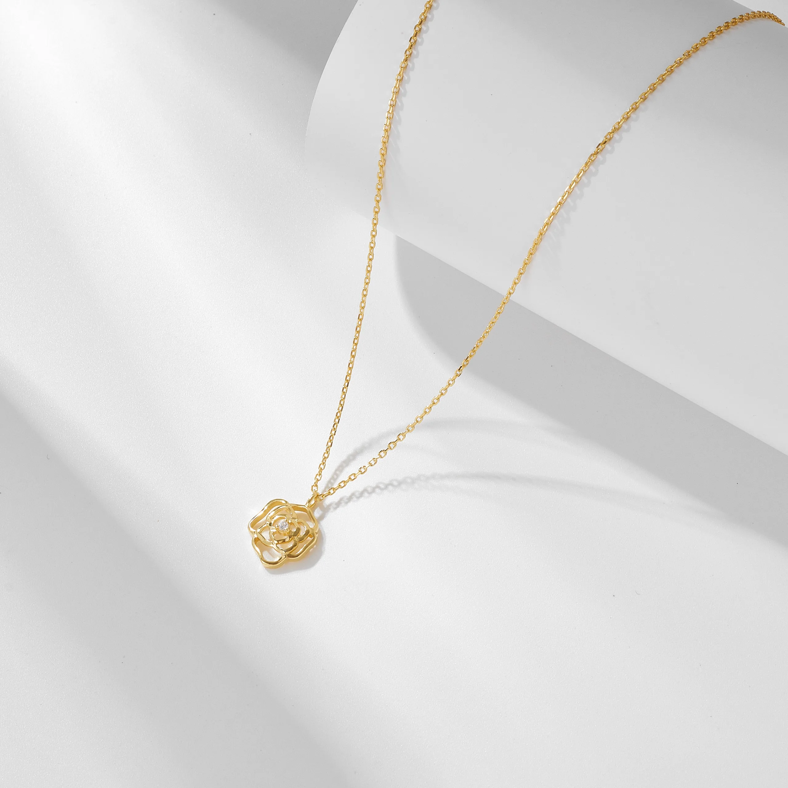 Gold plated rose pendant necklace, elegant floral jewelry for minimalist luxury fashion style.