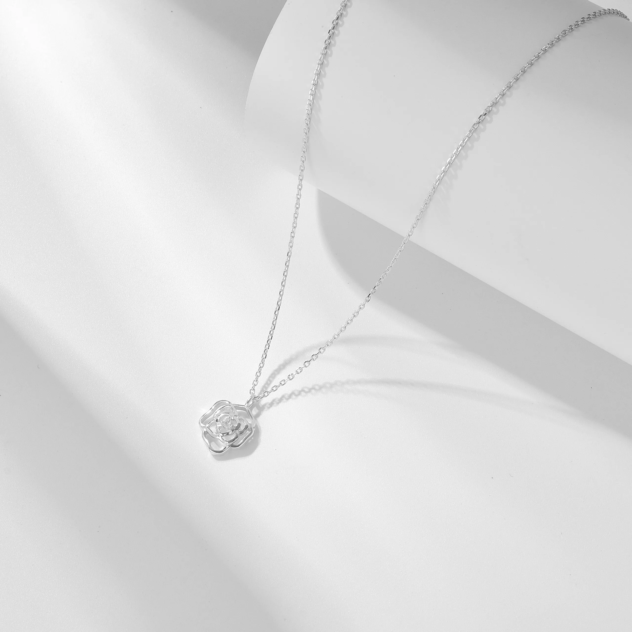 Sterling silver rose pendant necklace with delicate chain, timeless romantic jewelry handcrafted by Dorji Jewelry.