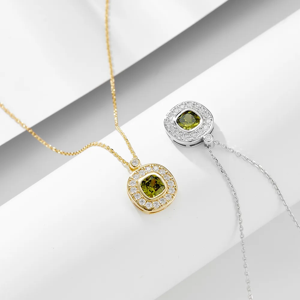 Green gemstone pendant necklace in gold and silver plating with halo cubic zirconia accents, elegant luxury design.