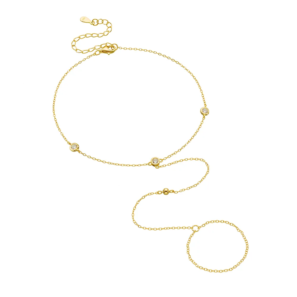 Delicate gold hand chain bracelet with bezel-set cubic zirconia, minimalist body jewelry handcrafted by Dorji Jewelry.