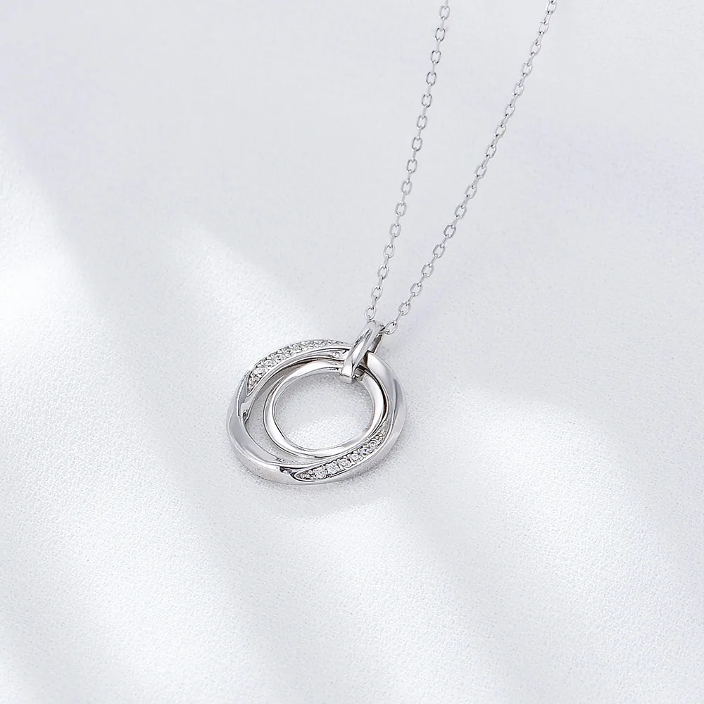 Sterling silver double circle pendant necklace with cubic zirconia detailing, elegant interlocking design.