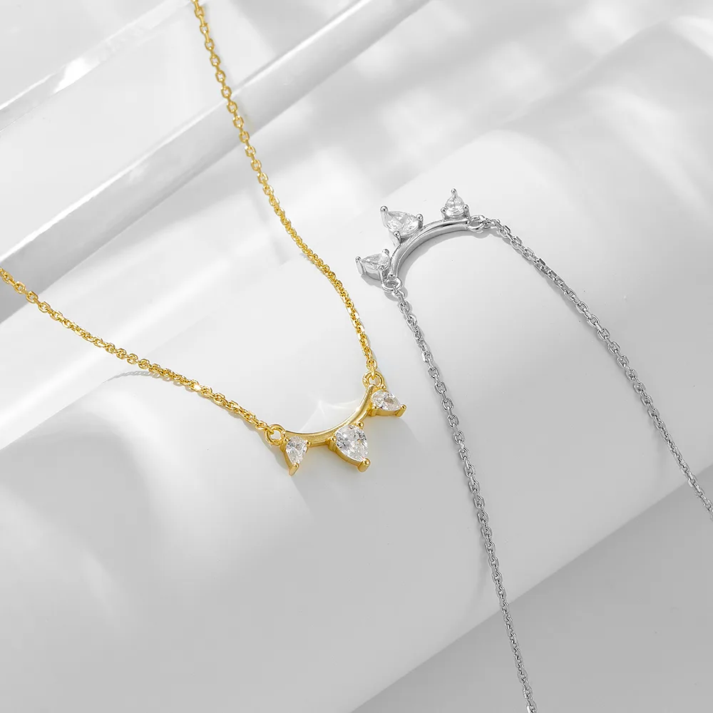 Dainty necklace in gold and silver tones with triple teardrop cubic zirconia, minimalist jewelry for everyday wear.