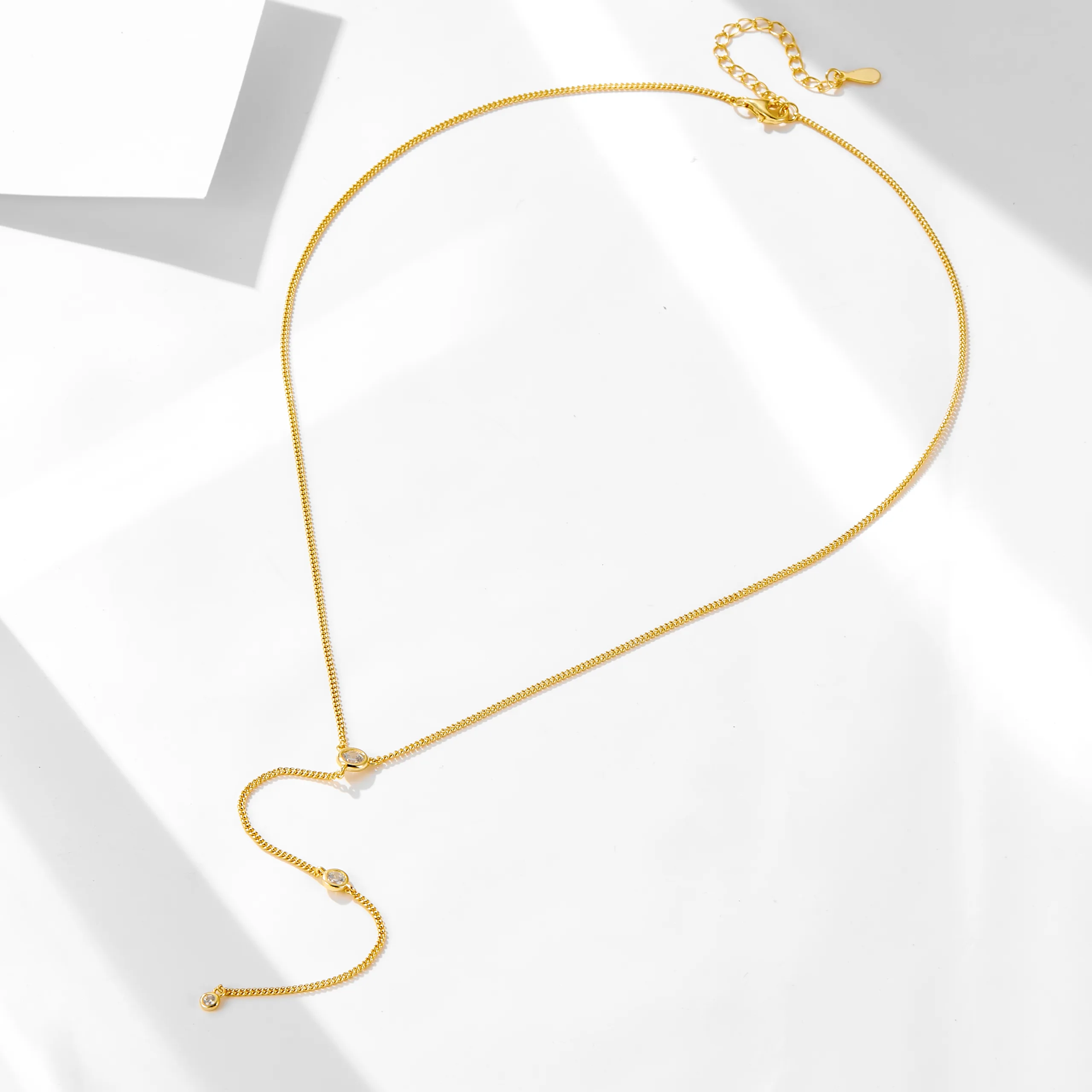 Minimalist gold Y necklace with cubic zirconia accents, elegant adjustable chain for modern layering style.