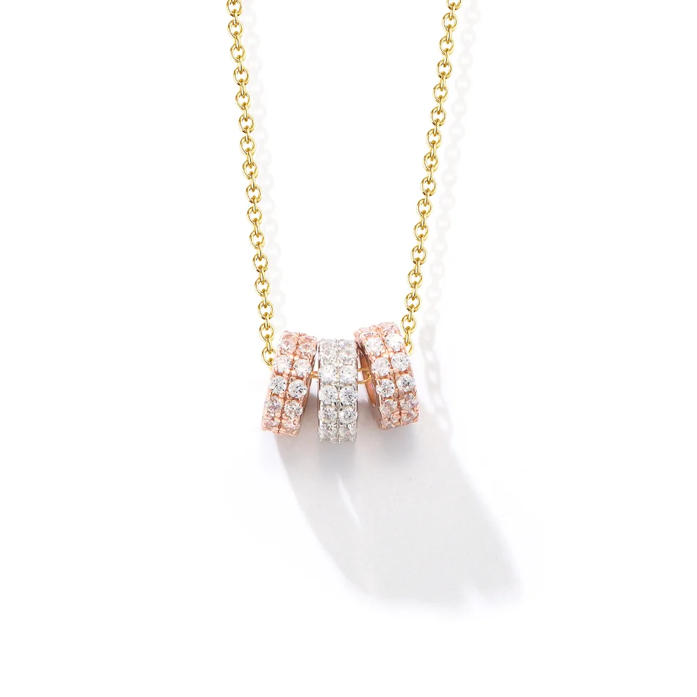 Triple ring pendant necklace in rose gold, silver, and gold tones with pavé cubic zirconia for a chic layered look.
