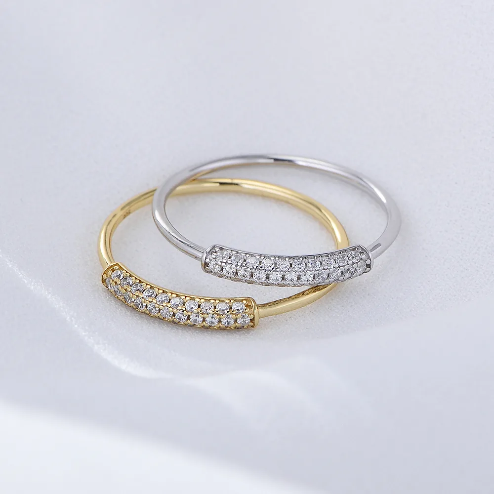 Dainty curved pavé rings in gold and silver, delicate minimalist design for everyday wear.