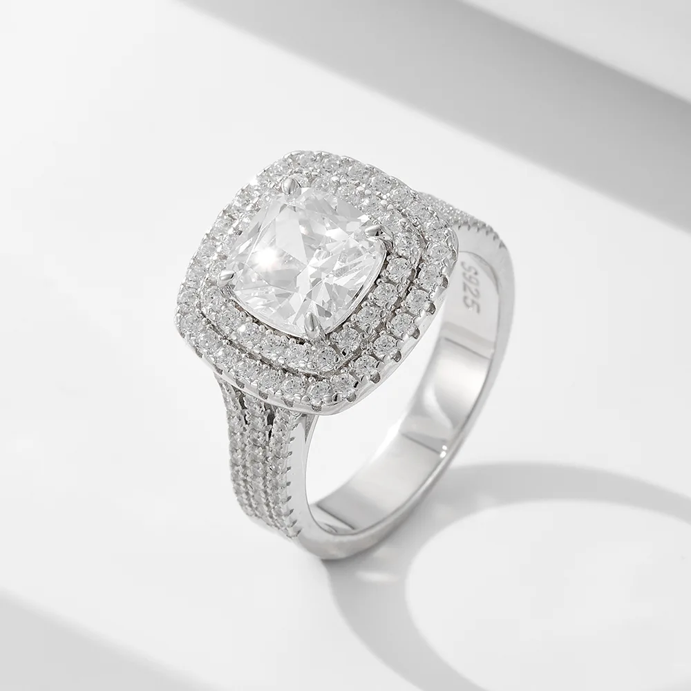 Sterling silver square halo engagement ring with double pavé band and cushion-cut center stone.